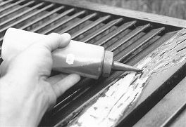 The decayed wood has been removed from this wood shutter. Liquid epoxy consolidant is applied, which will act as a primer for epoxy paste filler that will be applied next. 